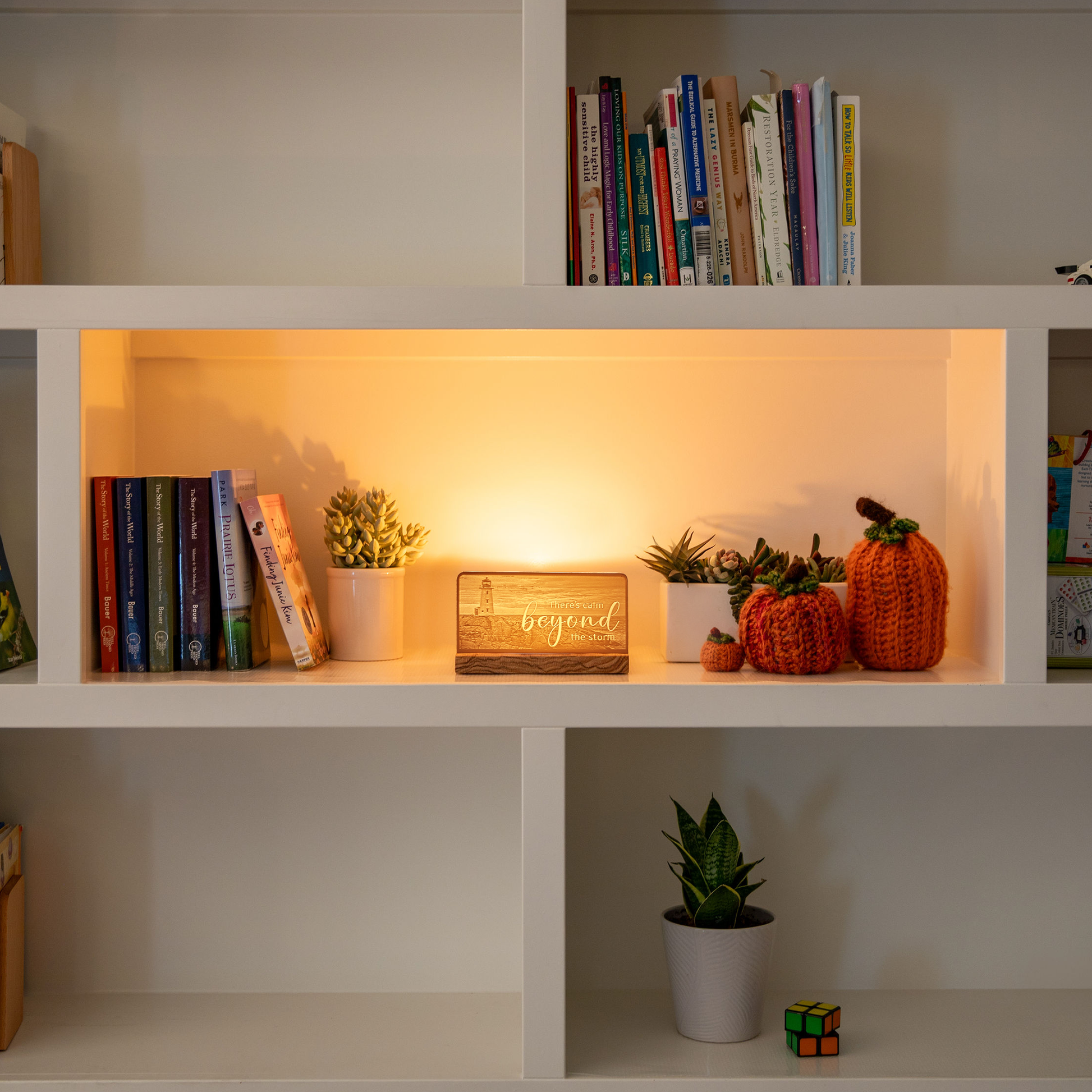 StoryLine-Mini lithophane photo display lit with Warm LED featuring a beach lighthouse scene and encouraging saying sitting on a contemporary home's bookshelf