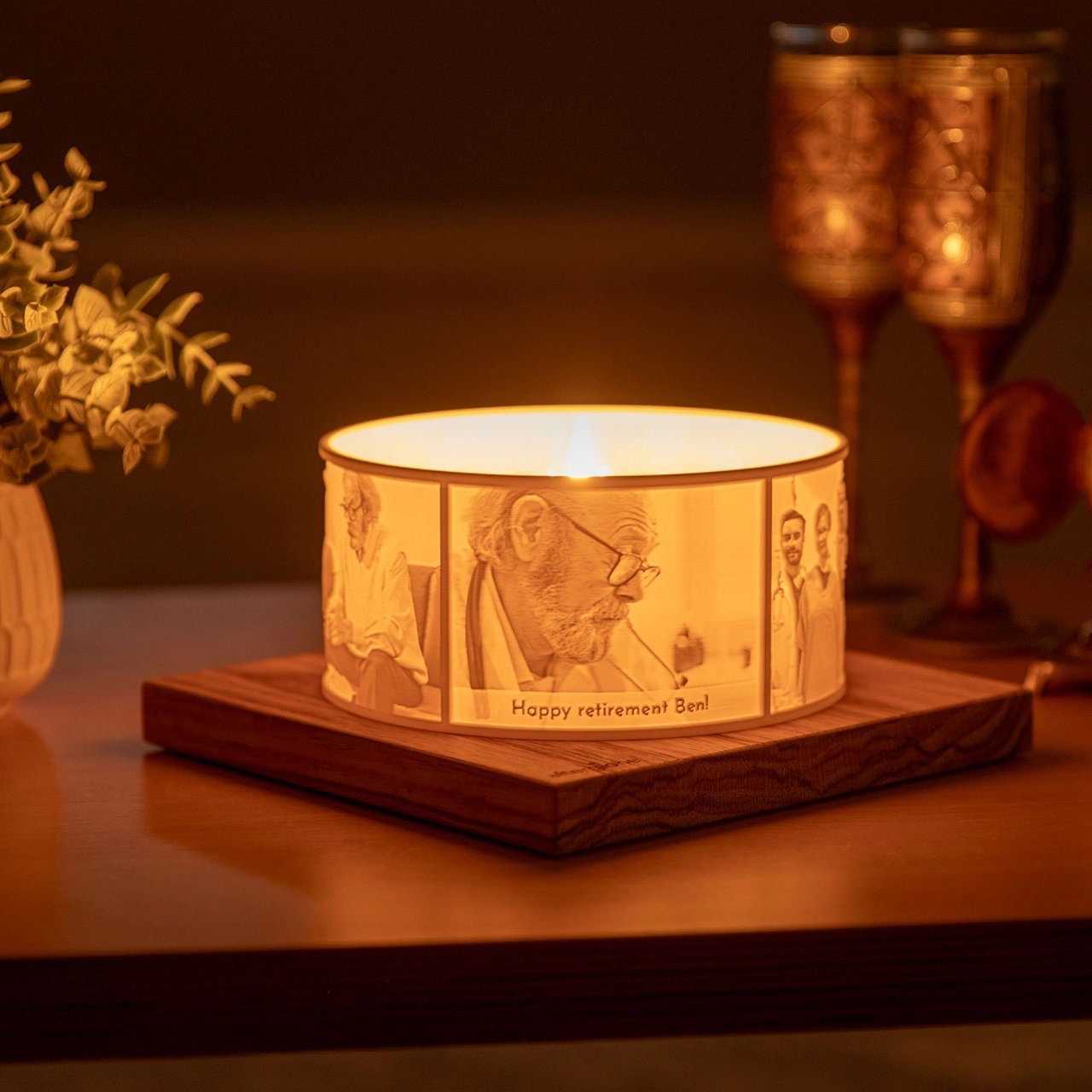 Halo personalized lithophane photo display on a wood base and scented candle given as a retirement gift from colleagues in a softly lit cosy living area