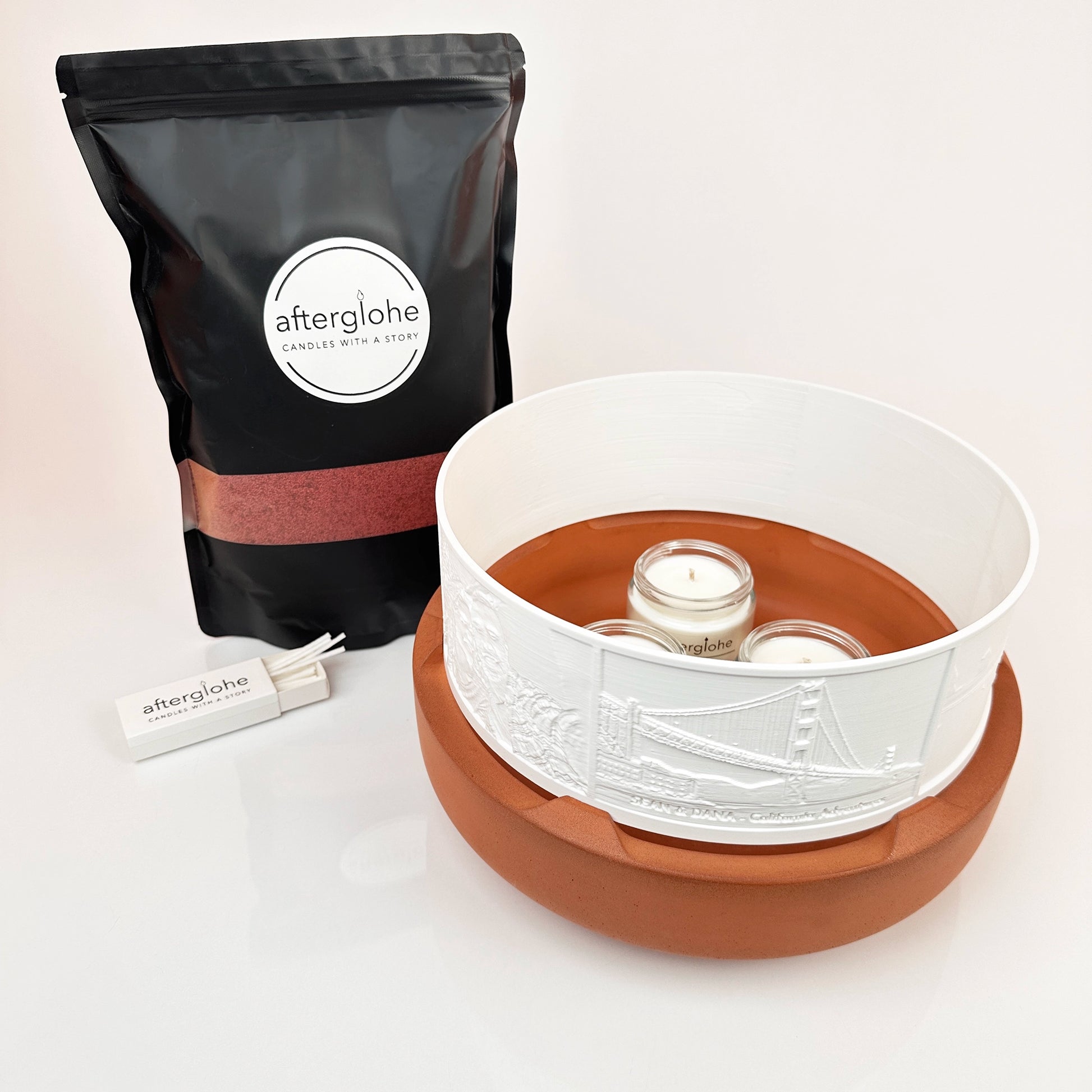Halo Grande personalized photo display with Desert Clay concrete base, Crimson Red Sand Wax and wicks, and three scented candles