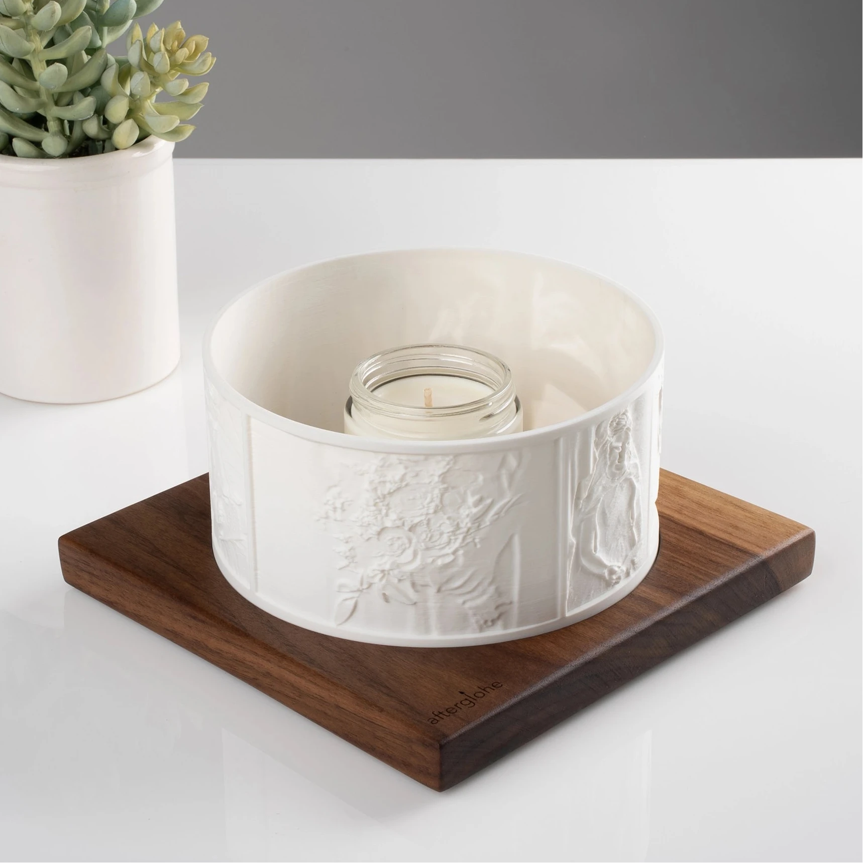 Halo personalized photo display on walnut base with candlelight and succulent in background