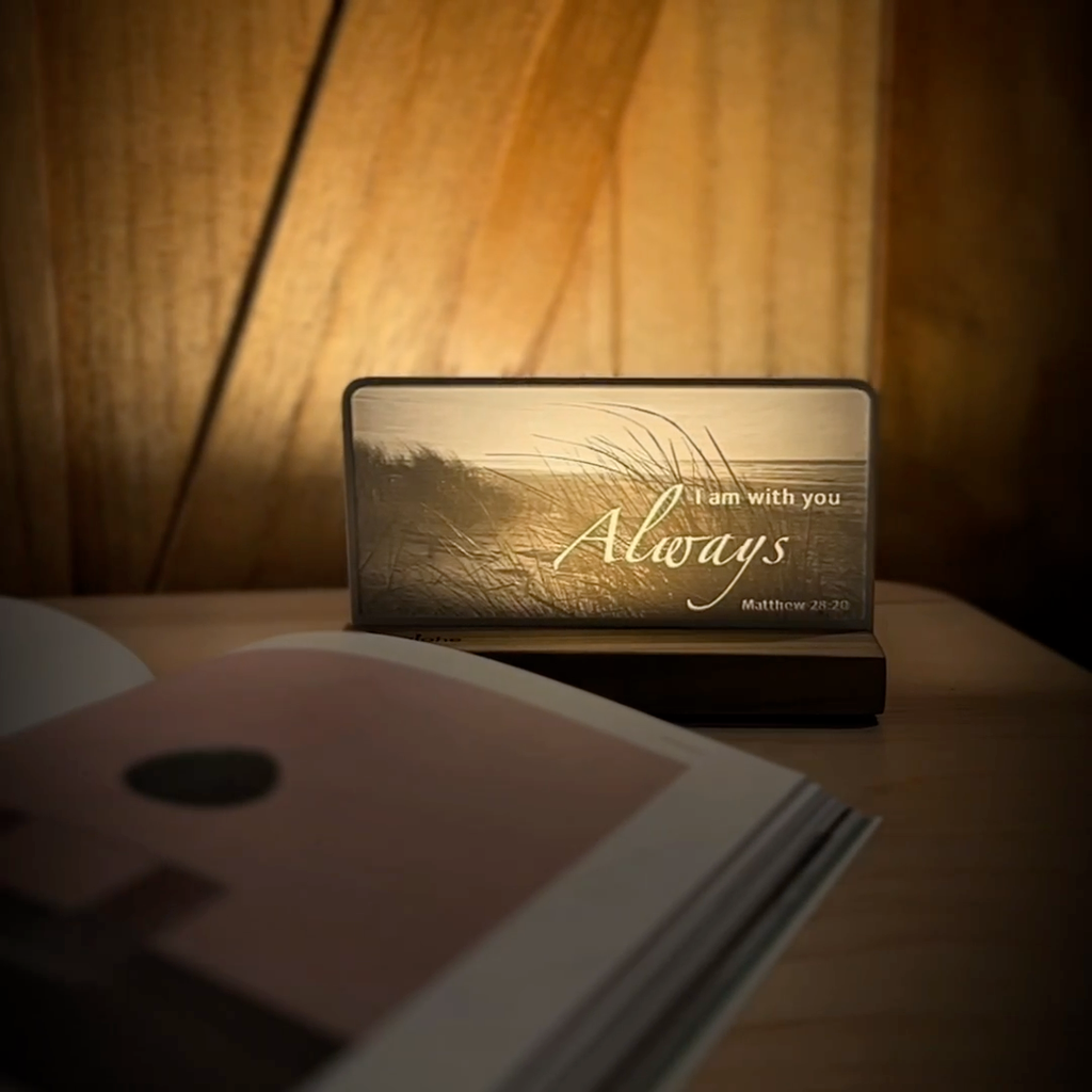 StoryLine-Mini lithophane photo display lit with Warm LED featuring a beach scene and encouraging Bible verse rotating on a small table