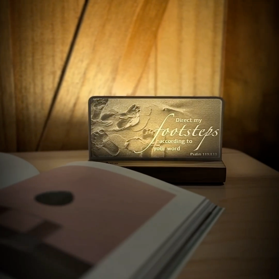 StoryLine-Mini lithophane photo display lit with Warm LED featuring a beach scene and encouraging Bible verse rotating on a small table