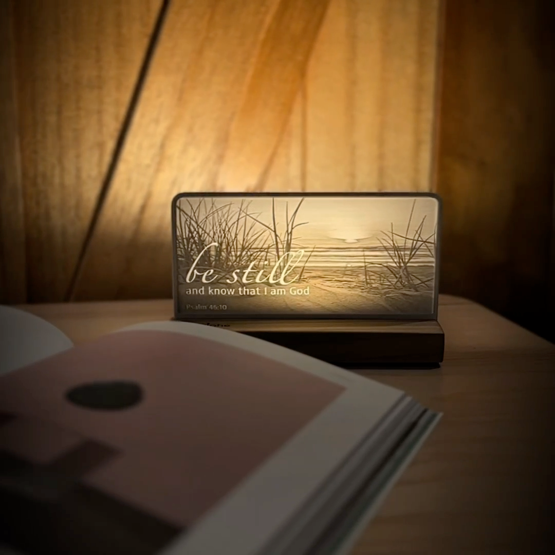 StoryLine-Mini lithophane photo display lit with Warm LED featuring a beach scene and encouraging Bible verse rotating on a small table