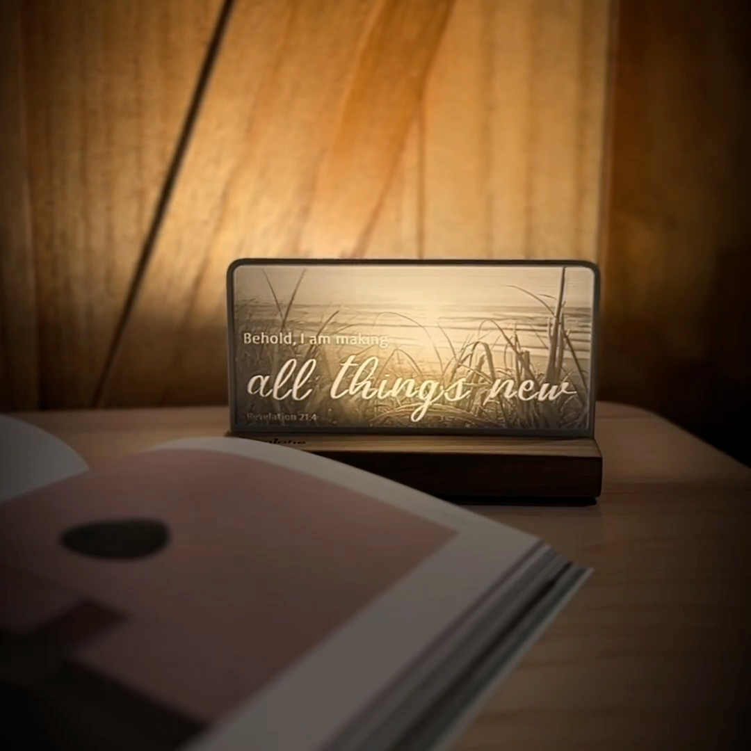 StoryLine-Mini lithophane photo display lit with Warm LED featuring a beach scene and encouraging Bible verse rotating on a small table