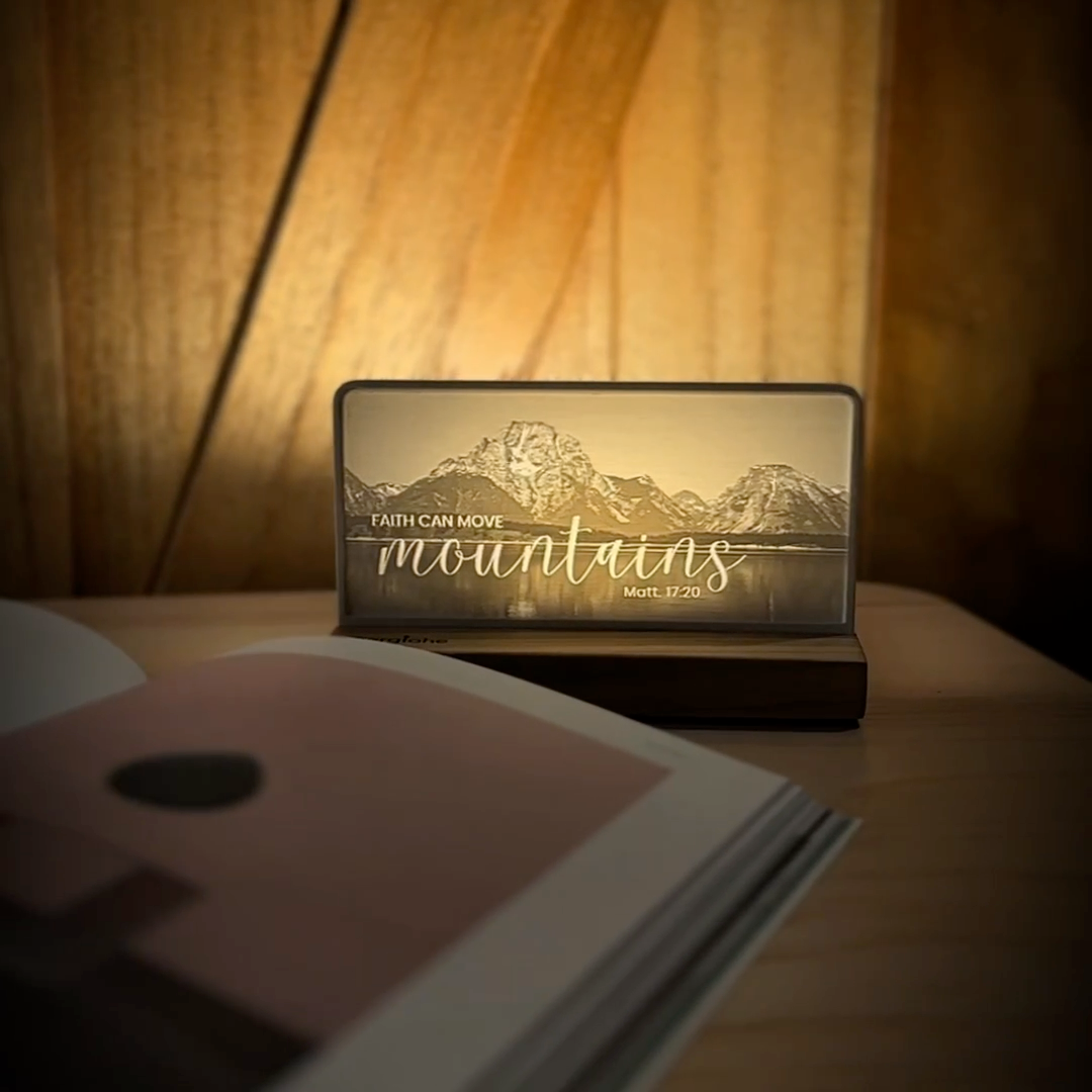 StoryLine-Mini lithophane photo display lit with Warm LED featuring a mountain scene and encouraging Bible verse rotating on a small table
