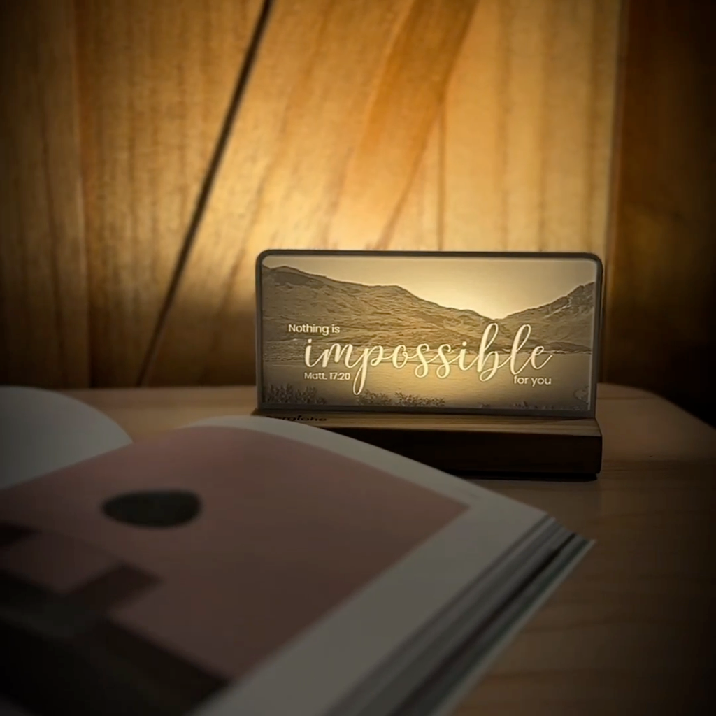 StoryLine-Mini lithophane photo display lit with Warm LED featuring a mountain scene and encouraging Bible verse rotating on a small table