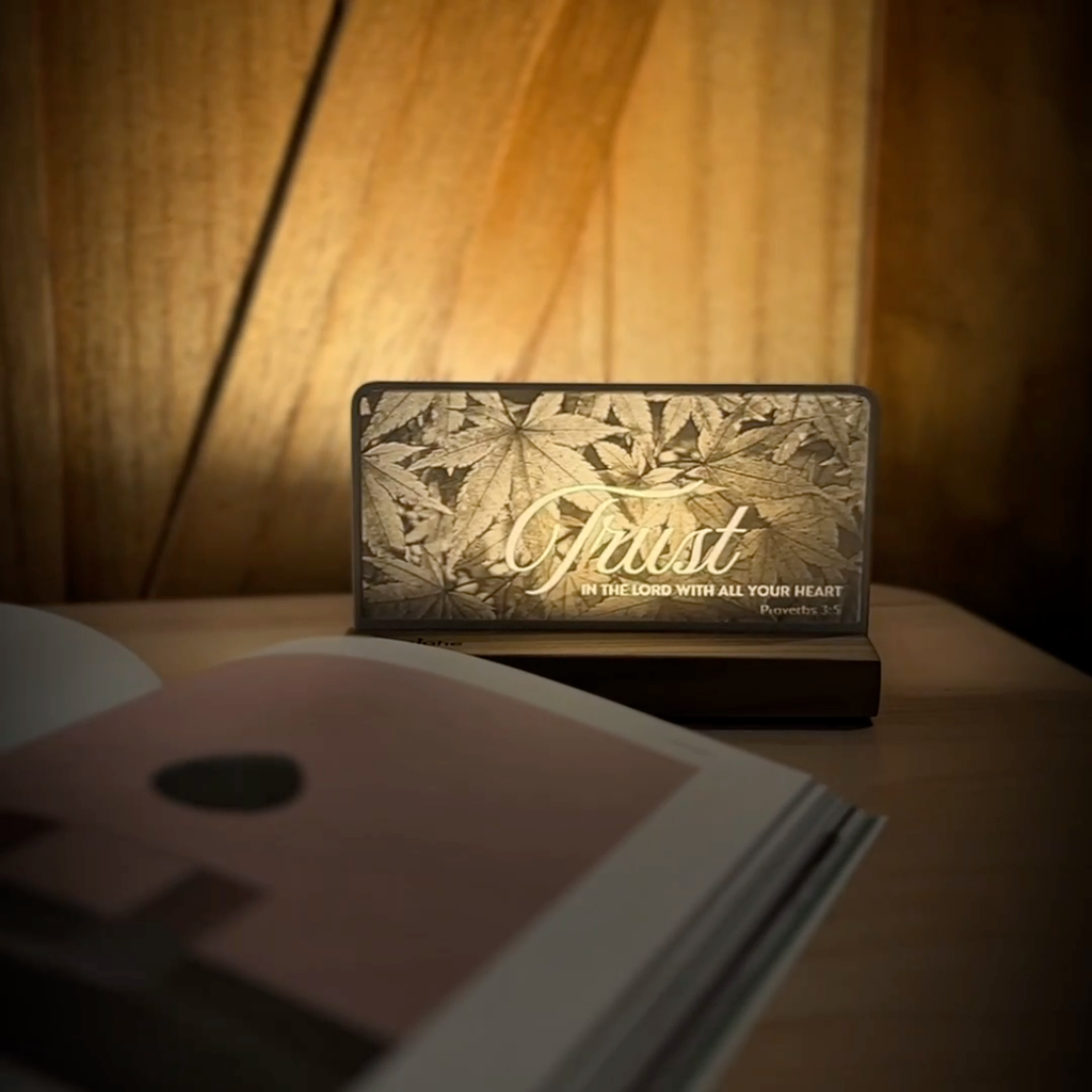 StoryLine-Mini lithophane photo display lit with Warm LED featuring a nature scene and encouraging Bible verse rotating on a small table