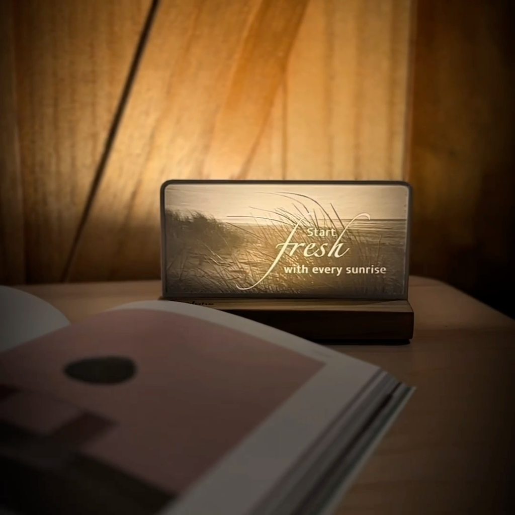StoryLine-Mini lithophane photo display lit with Warm LED featuring a beach scene and encouraging saying rotating on a small table