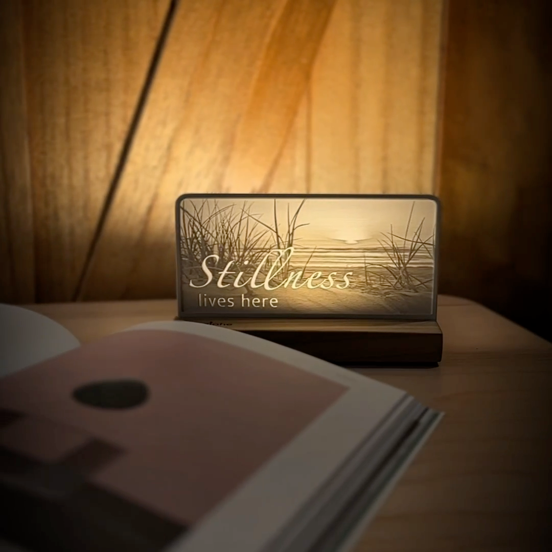 StoryLine-Mini lithophane photo display lit with Warm LED featuring a beach scene and encouraging saying rotating on a small table