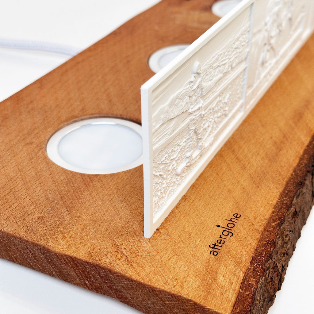 Close-up detail of afterglohe StoryLine Photo Display lithophane product showing Rustic Live Edge Base with logo engraving and LED illumination