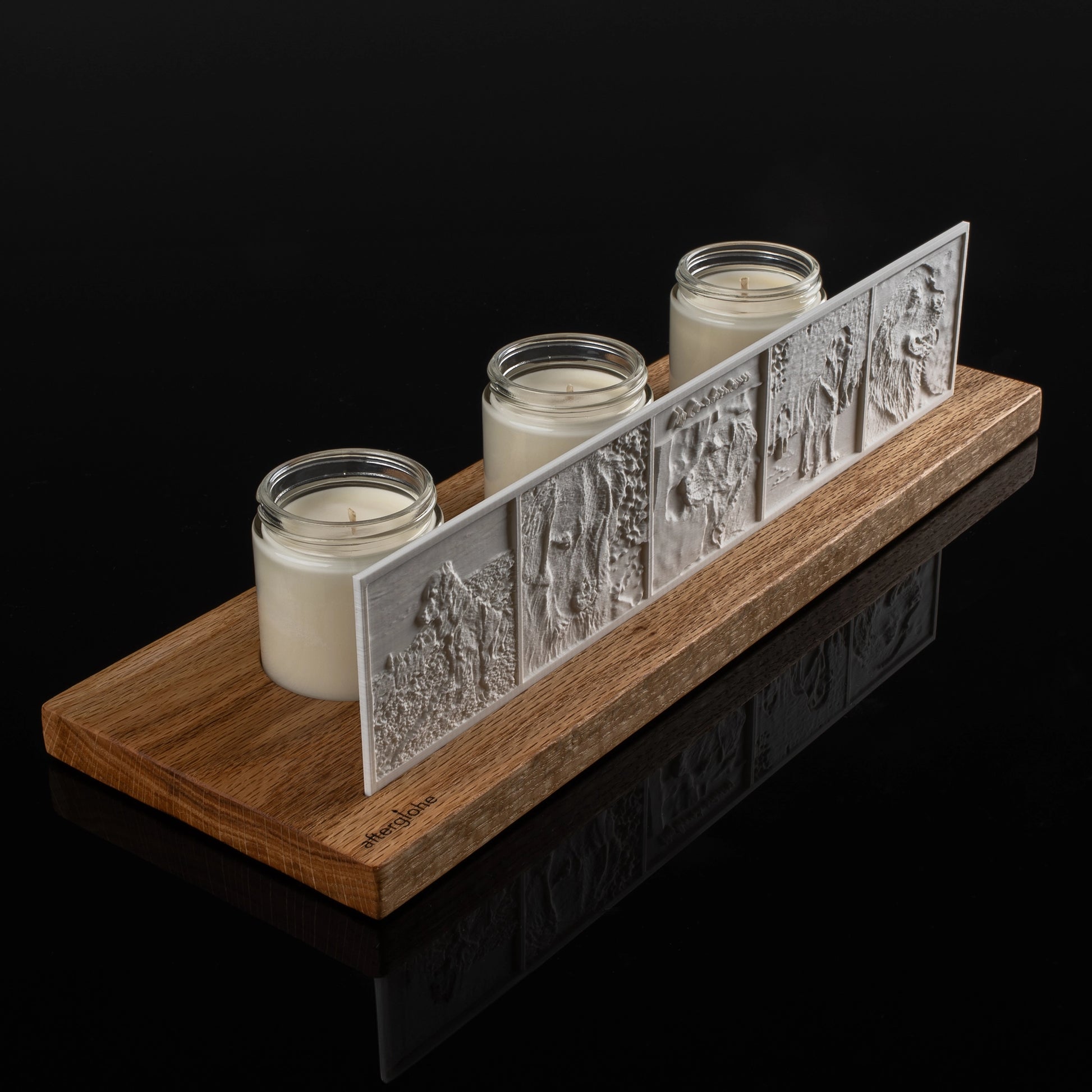StoryLine personalized photo display illuminated with three candles on a black background